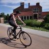 Female student riding bike on campus