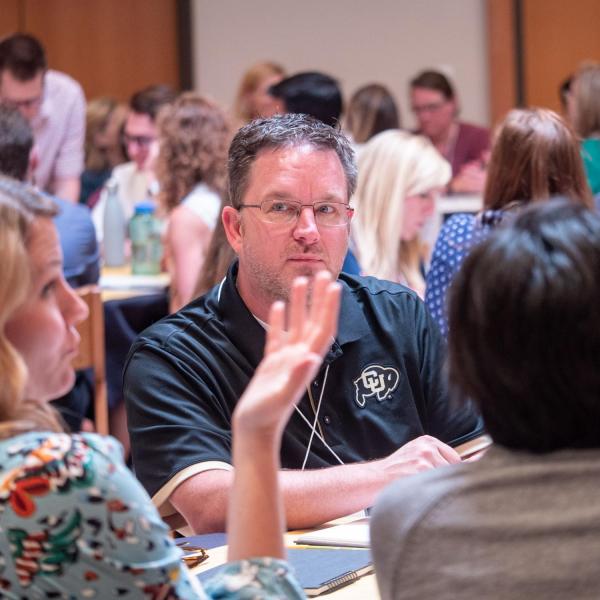 Athletics Associate SID and Internet Managing Editor Troy Andre listens during the tabletop discussions at the Fall 2018 Campus Communicators Conference