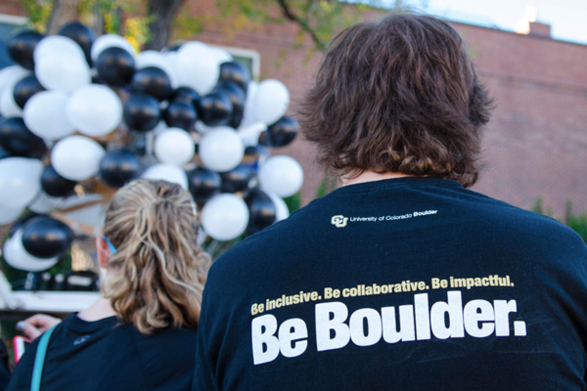 Back of a student with a shirt that reads "Be Boulder"