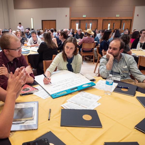 Jeff Zehnder, Kellen Short and others engage in a group tabletop discussions at the Fall 2018 Campus Communicators Conference