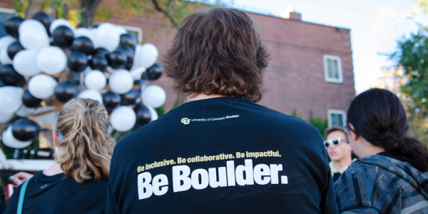 Back of a student with a shirt that reads "Be Boulder"