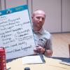 Student Affairs Communications and Marketing Coordinator Jesse Peterson shows his table's communications priorities at the Fall 2018 Campus Communicators Conference