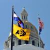 U.S., Colorado state and CU Boulder flags flying at the capitol