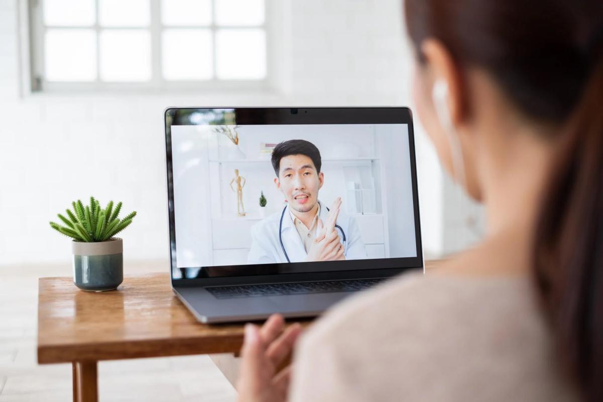 Photo of a woman meeting with a provider on her laptop.