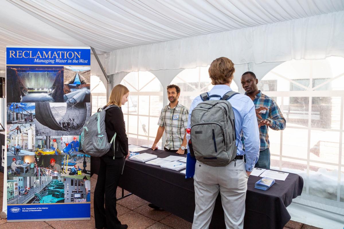 Students talking to employers at a career fair