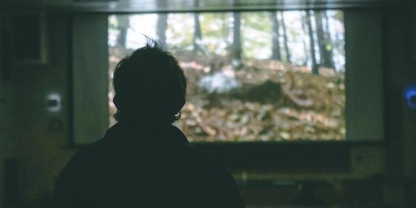 A student watching a movie on campus