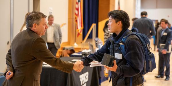 A student meets with a recruiter at the Just in Time Career Fair on campus