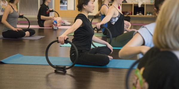 A group of people take a Pilates class at the Rec Center