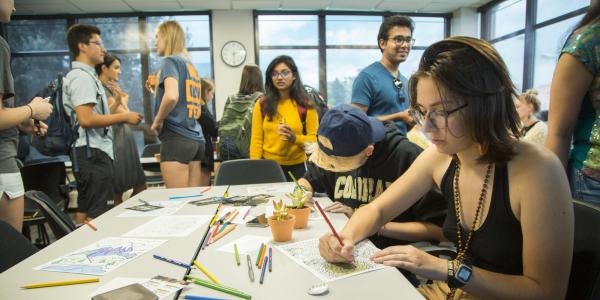 Students around an table doing an activity