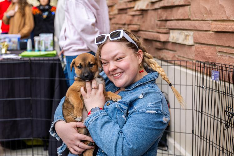 A girl holding a puppy