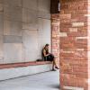 student sitting outside campus building