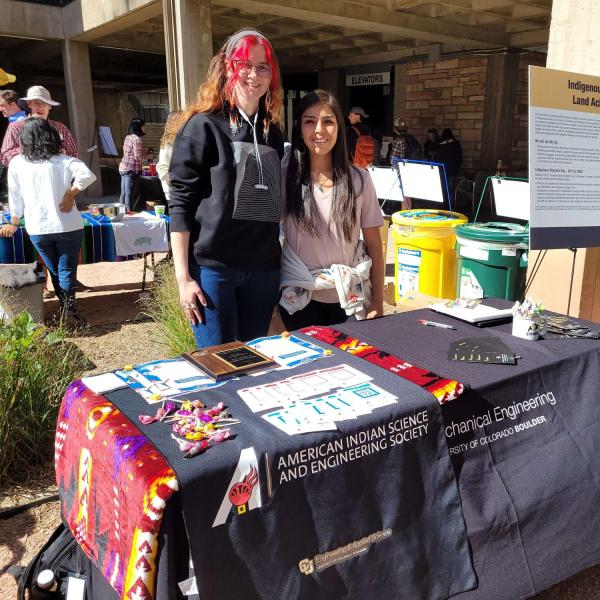 AISES members standing by their table at the 2022 fall festival hosted by the mechanical engineering department