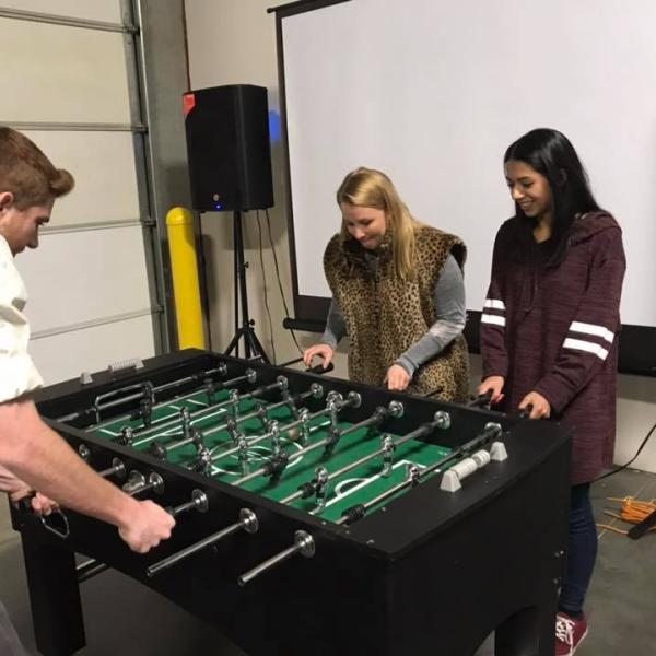Ambassadors playing Foosball at the Fall 2018 Banquet