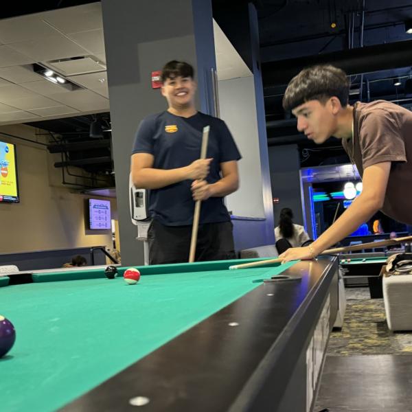 Members of Titans Productions playing pool.