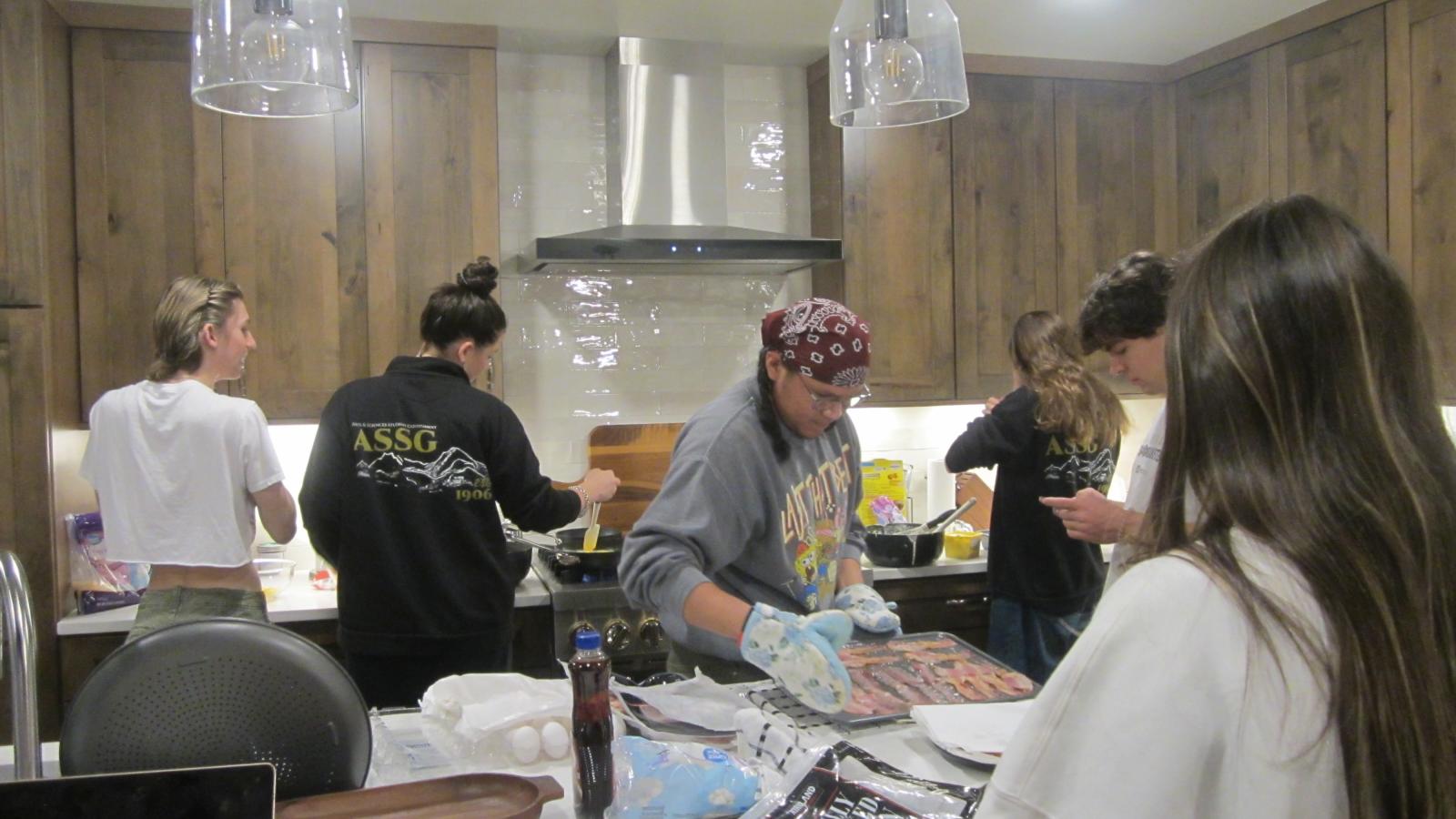 Members making dinner.