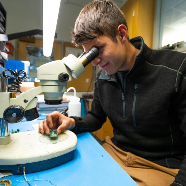 Student looking into microscope