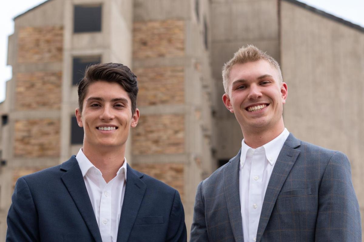 Tyler Cagle and Reese Barracks stand in front of the CU engineering building