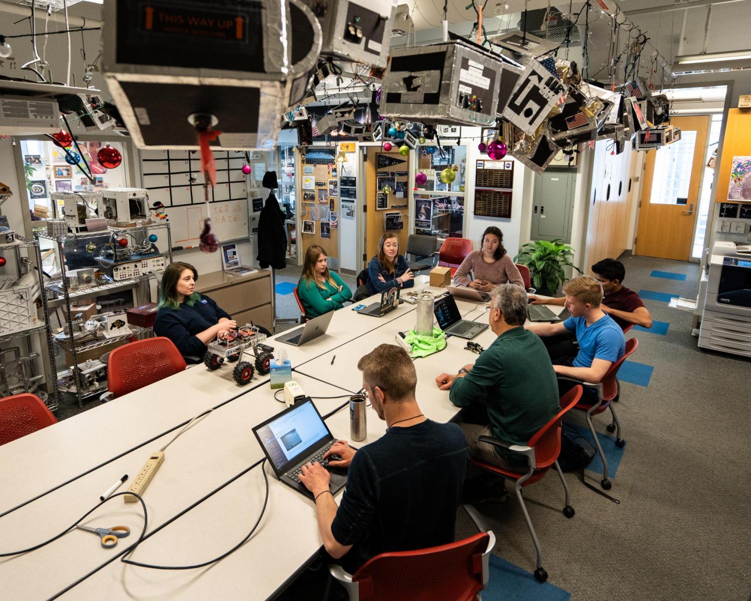 Students working at table inside space center