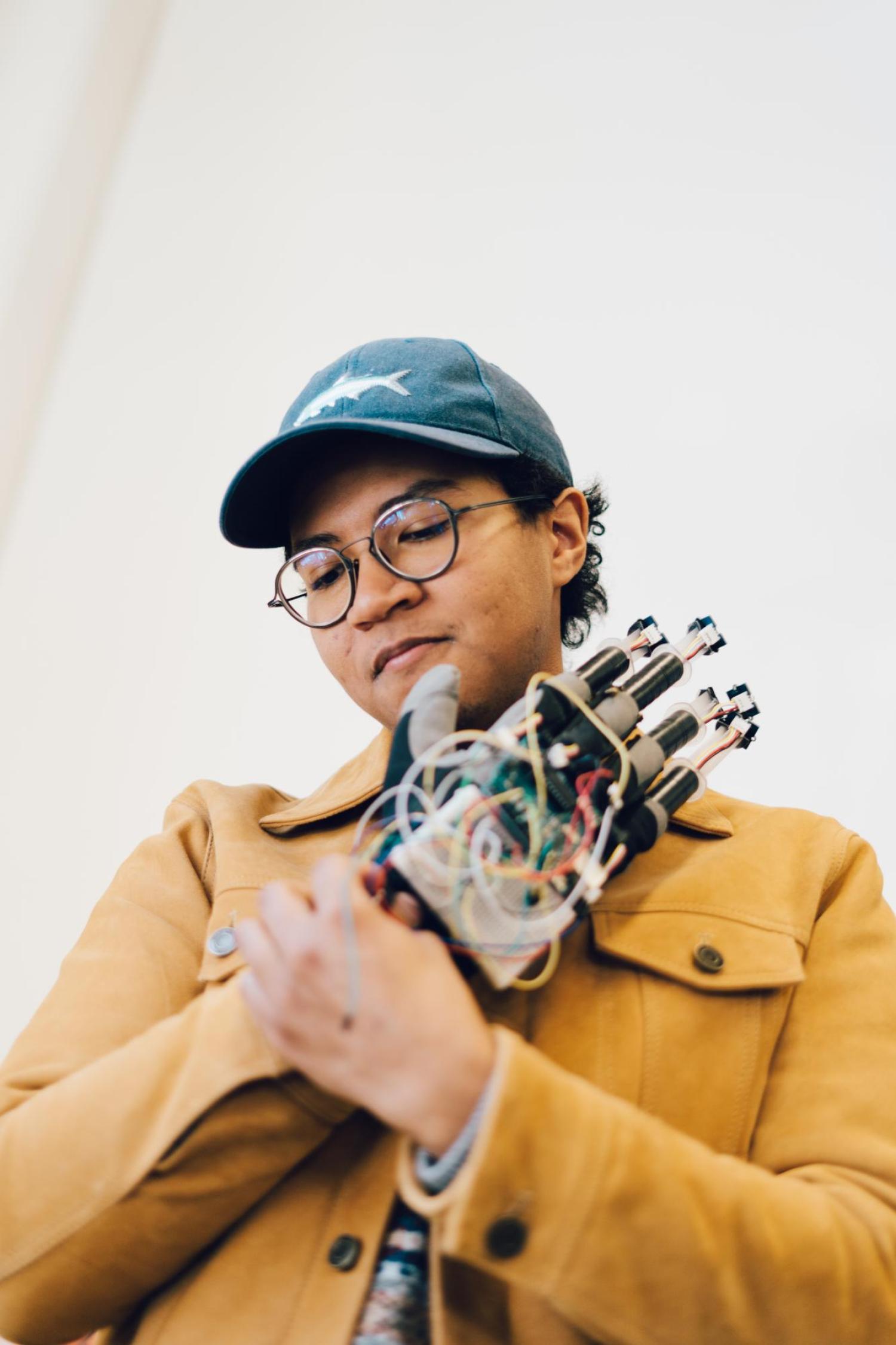 Christian Hill with a robotic hand