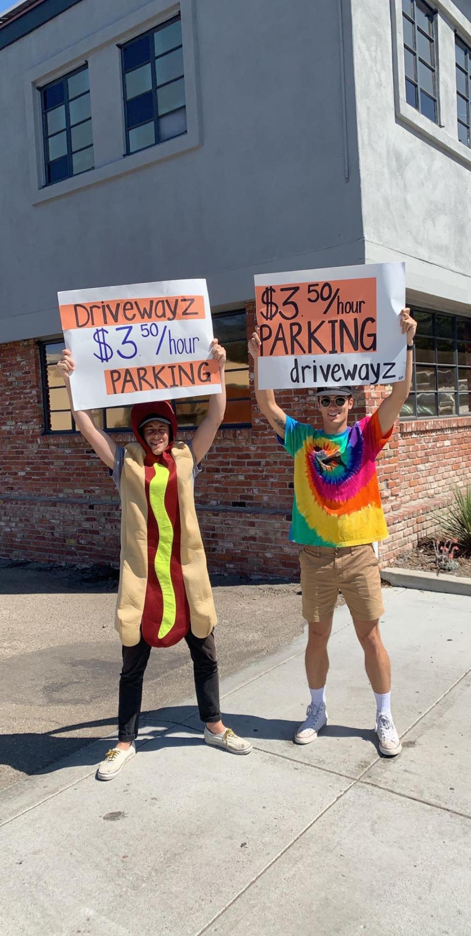 Tyler Cagle in hotdog suit holding parking advertising sign