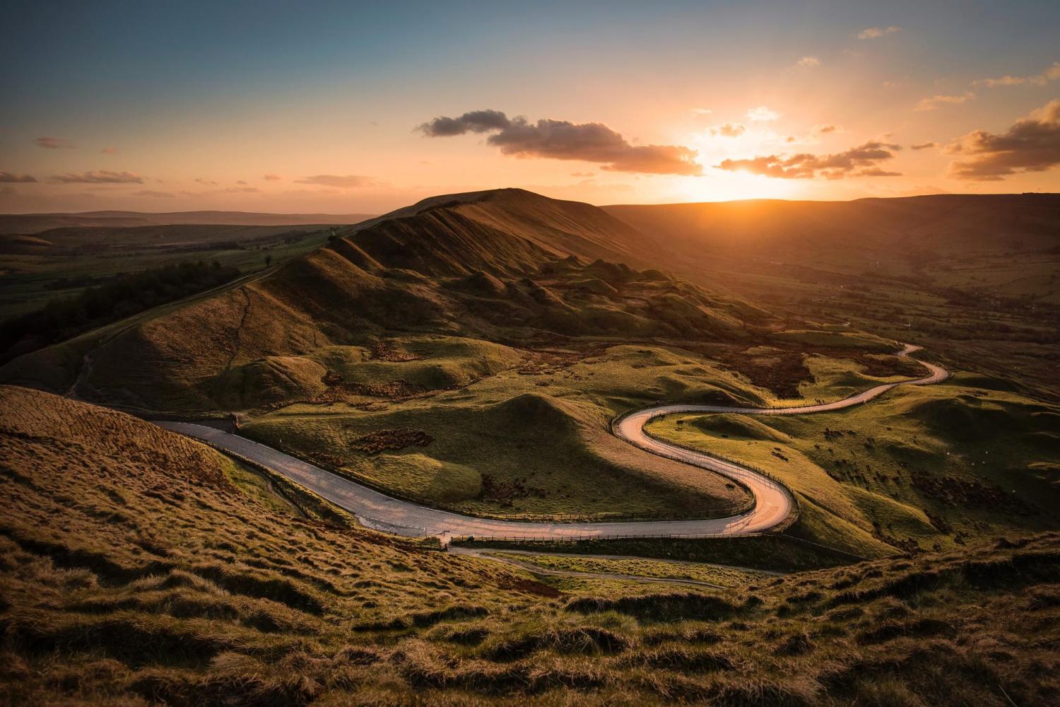 Landscape with twisting mountain road and sunset