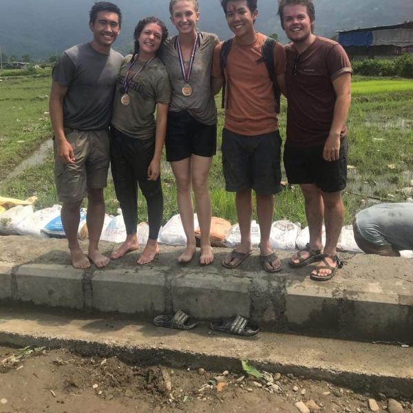 GROW interns from 2019 smiling in a rice field.
