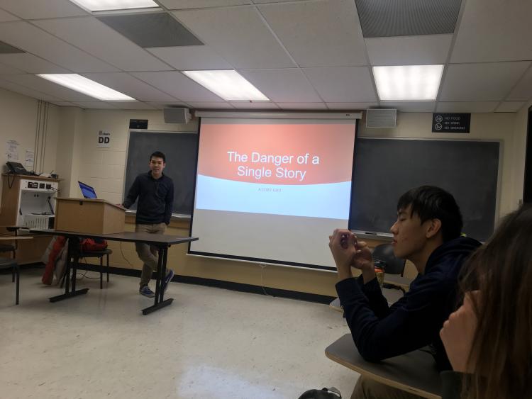 The president Cory Wong presenting a Global Health Unit at a GlobeMed meeting.