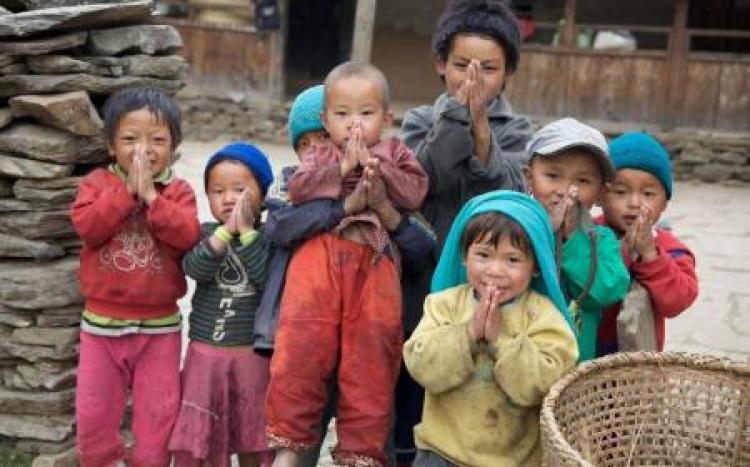 Children in a village greet a passerby