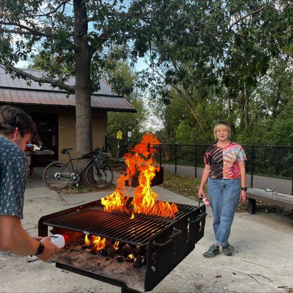 Picture of two grad students by the grill.