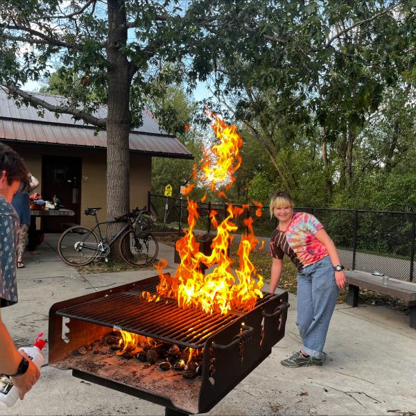 Picture of two grad students by the grill.