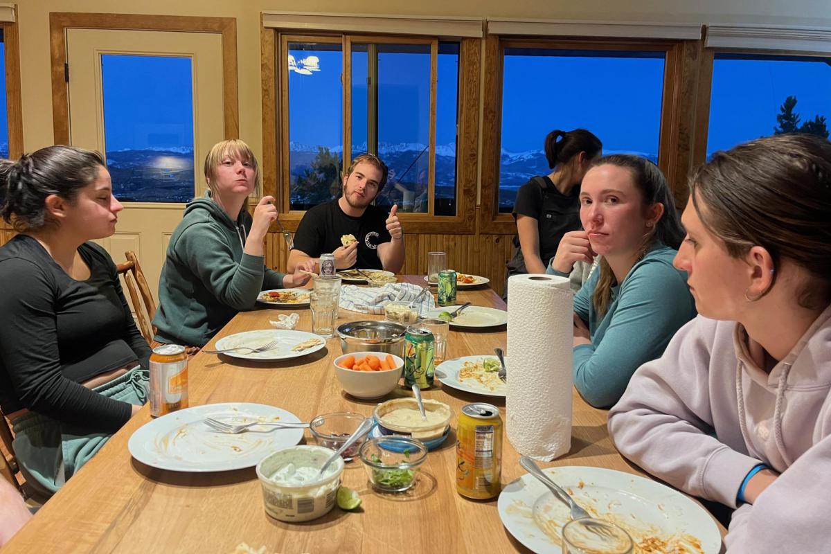 close up of people gathered around a dinner table