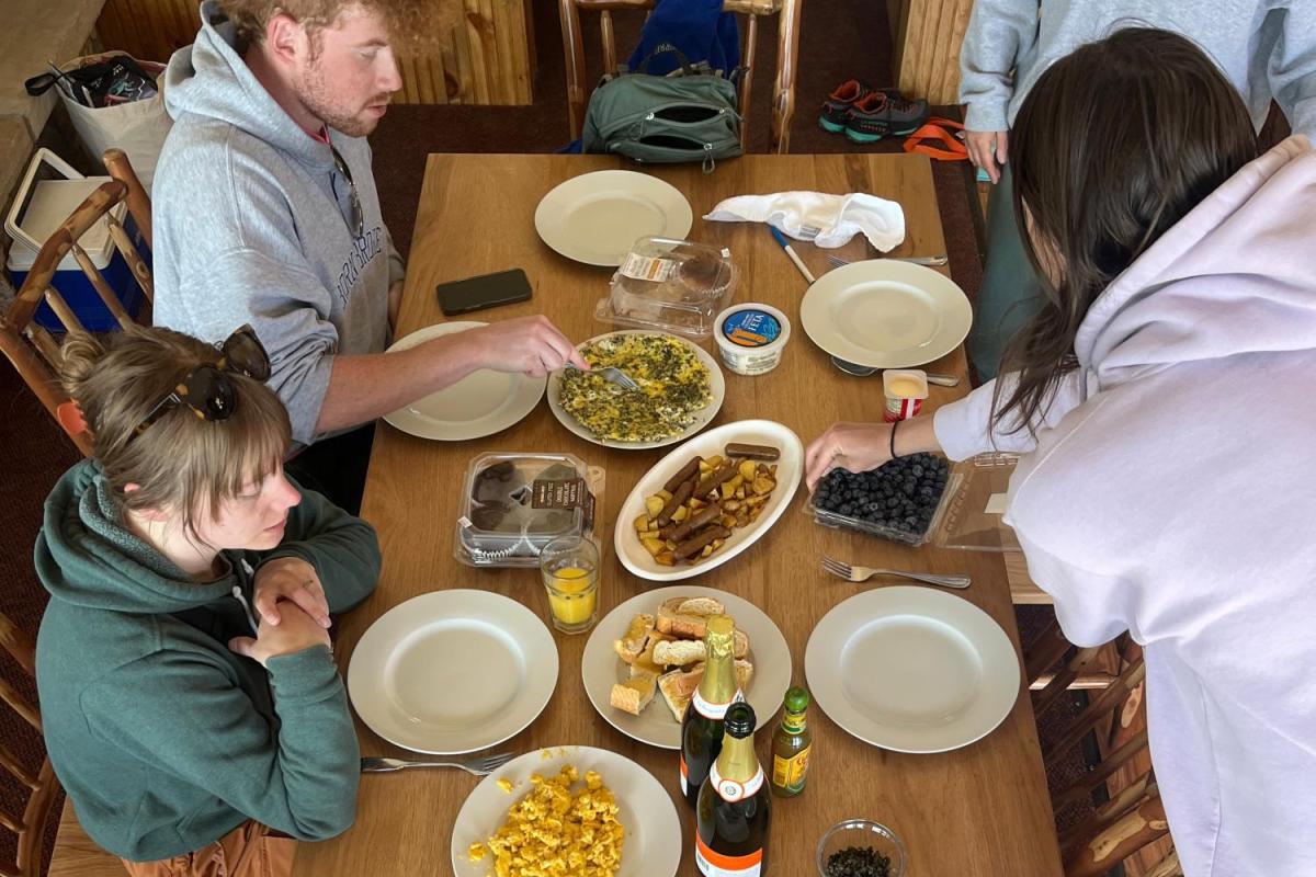 bird's eye view of a breakfast table and 3 people gathered around
