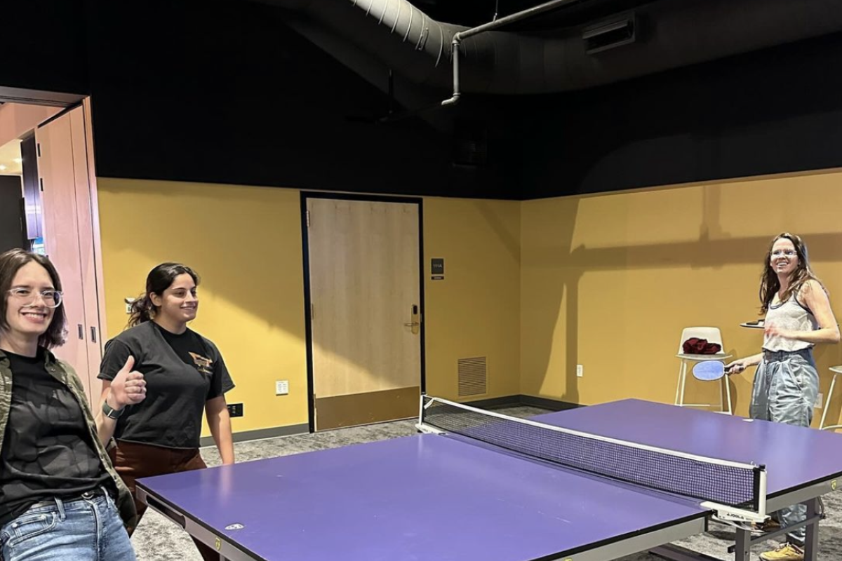 3 people playing ping pong