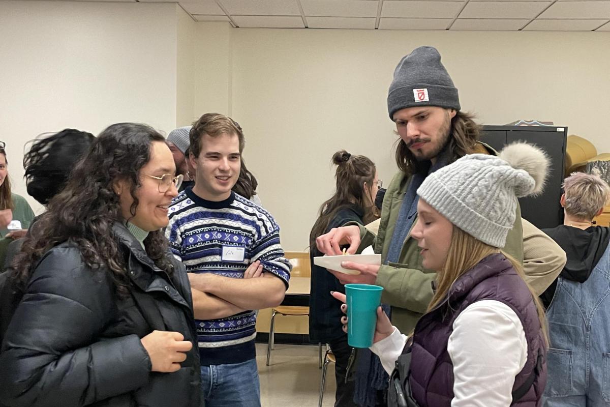 group of white people in their 20s standing in a circle and talking