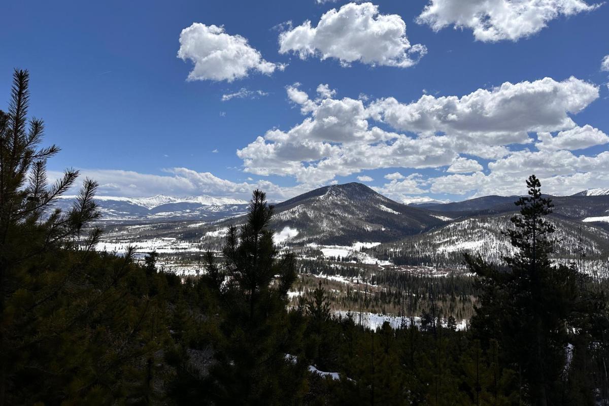 mountain in the distance under clouds in blue sky