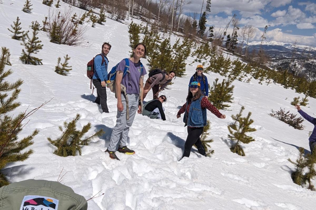 a group of people standing in the snow