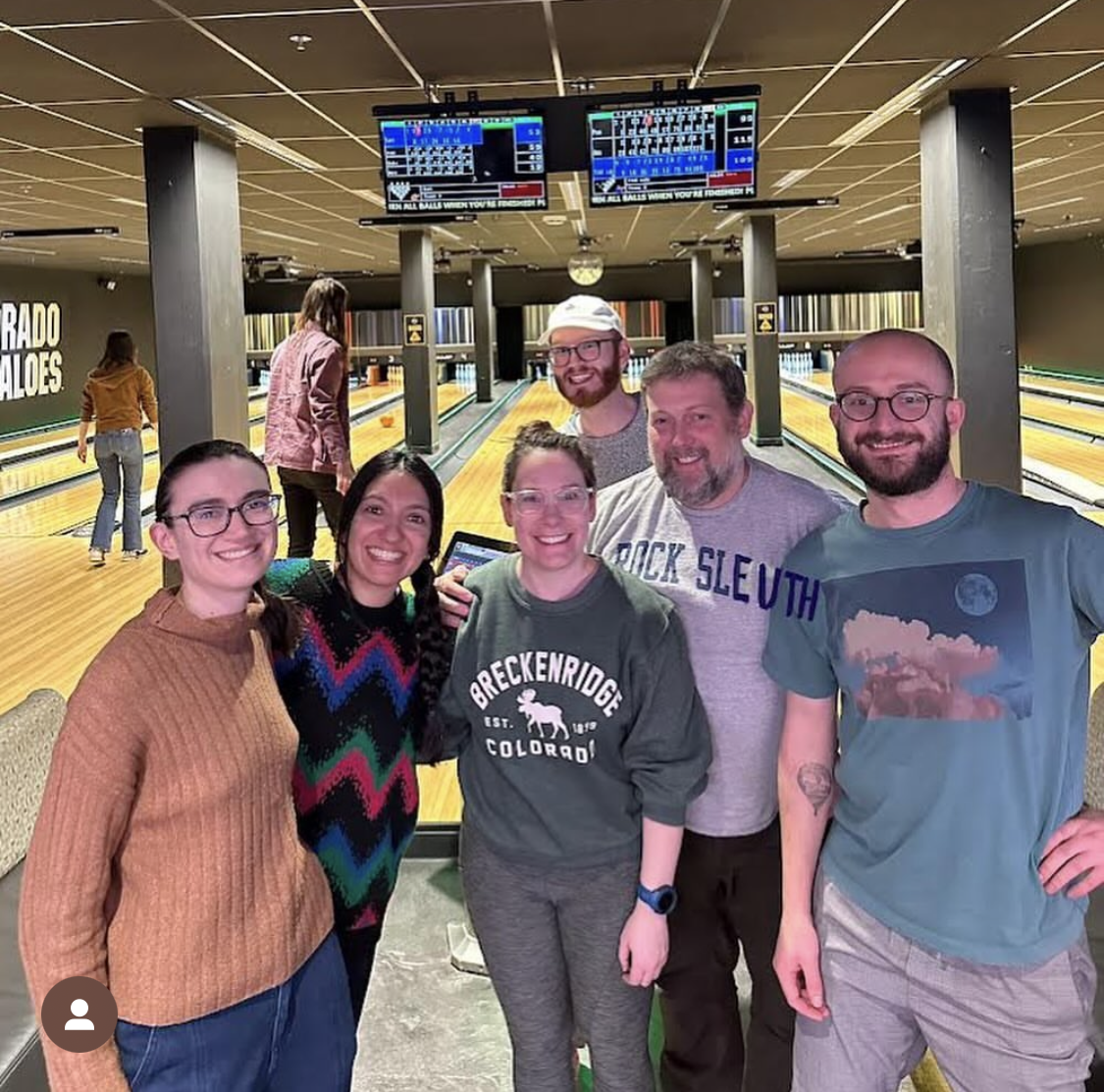 a group of people in front of bowling lanes