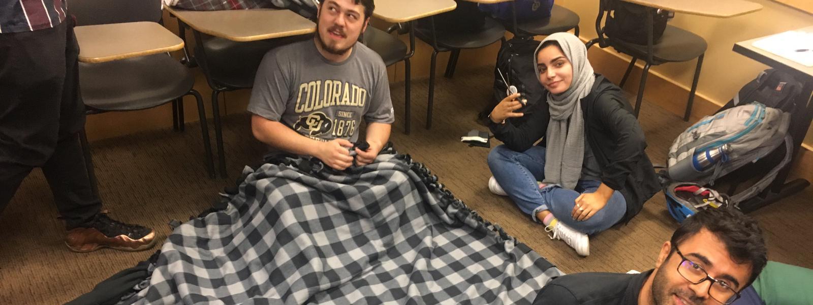 Muslims making blanket for the homeless