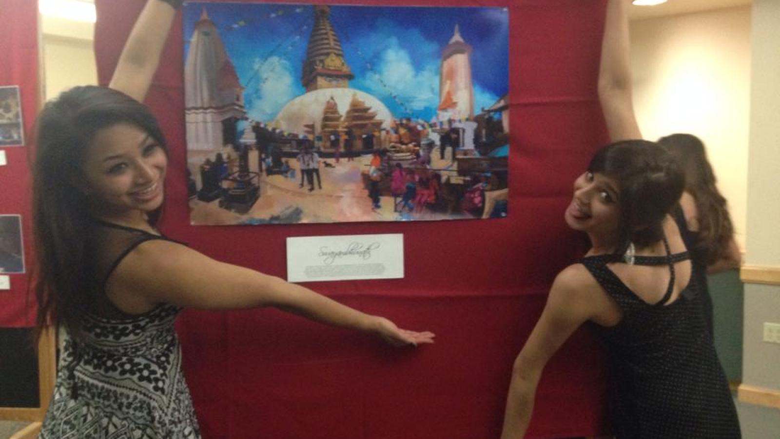 Student with art display at exhibit