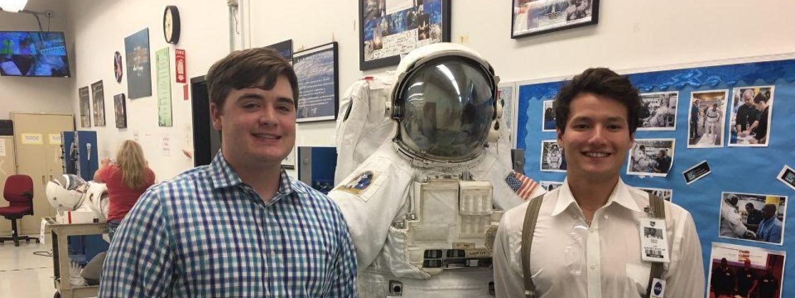 Members posing with an astronaut suit
