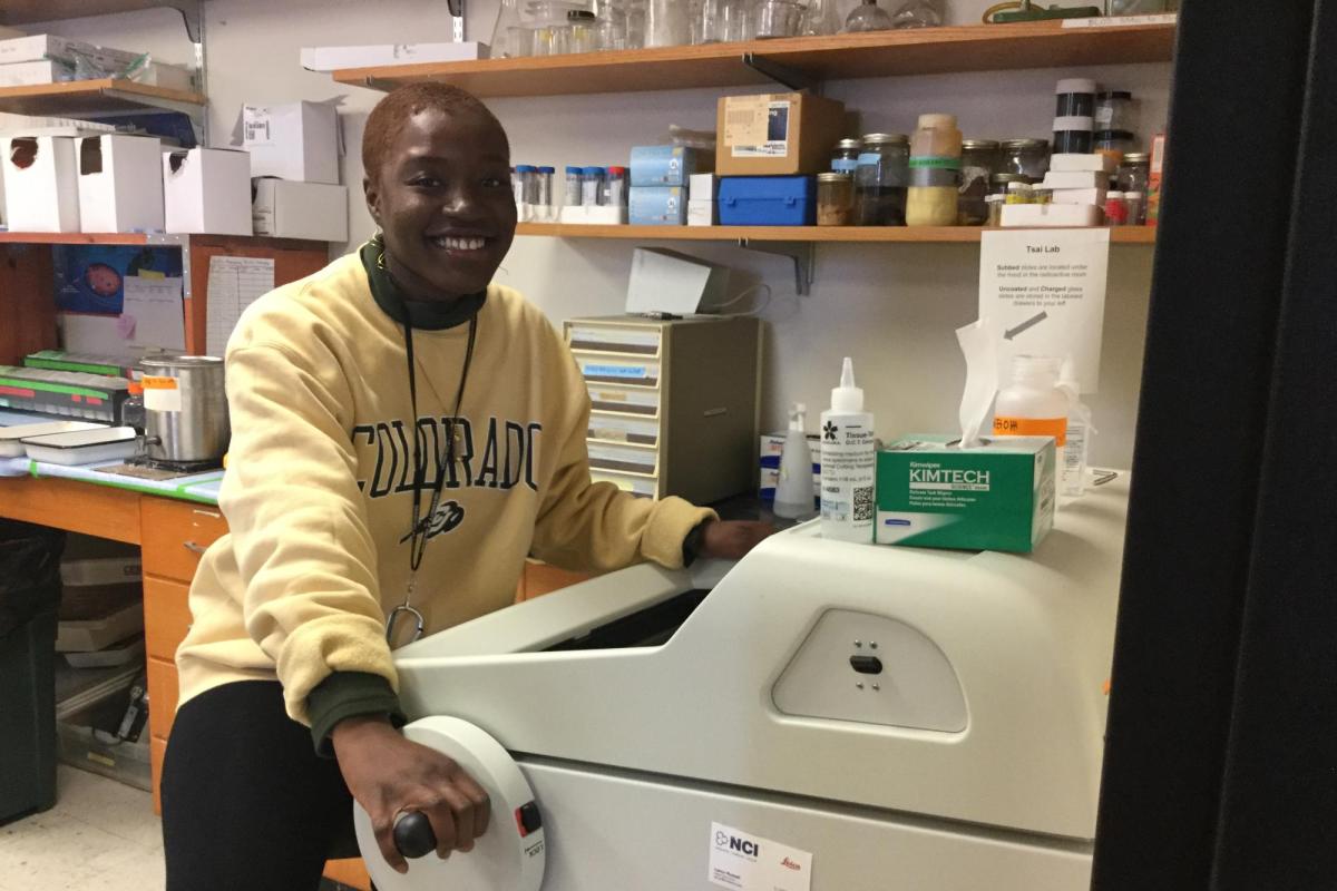 A Black undergraduate student learns how to operate a lab instrument.