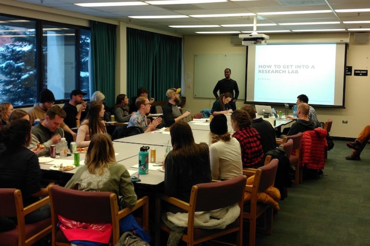 Room full of students watching a presentation on the projector