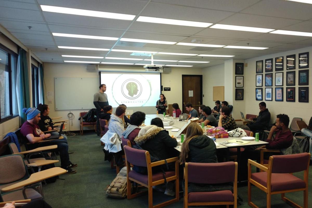 classrooms with students sitting, and two presenters