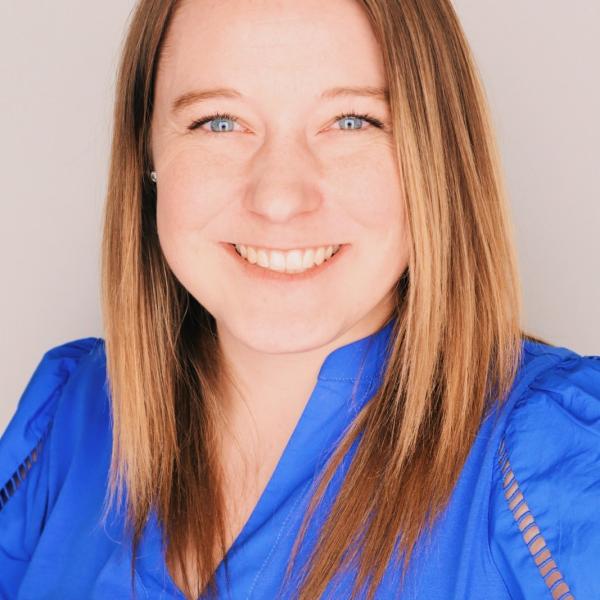 Image of Brooke Nelson. Average height. Dirty blonde hair. Wearing a blue shirt.