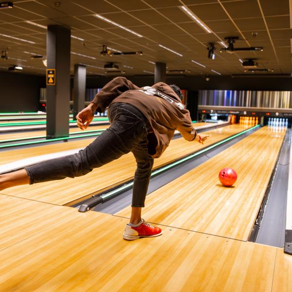 A student bowling at The Connection