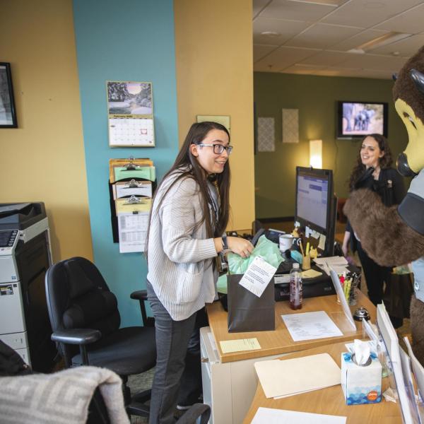 Chip visits the Office of Victim Assistance staff to hand out gift bags and pose for pictures during Random Acts of Kindness Week