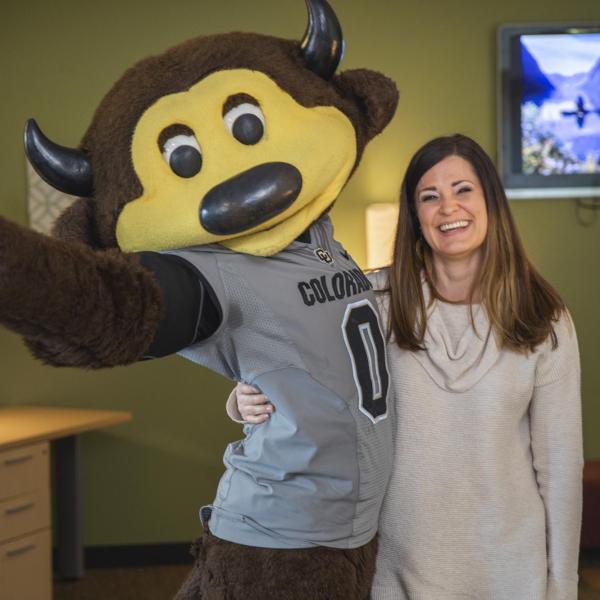 Chip visits the Office of Victim Assistance staff to hand out gift bags and pose for pictures during Random Acts of Kindness Week