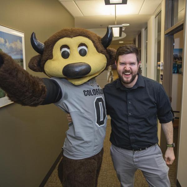 Chip visits Student Support and Case Management staff to hand out gift bags and pose for pictures during Random Acts of Kindness Week