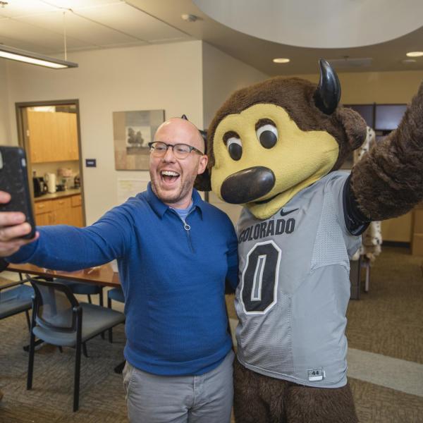 Chip visits Student Support and Case Management staff to hand out gift bags and pose for pictures during Random Acts of Kindness Week