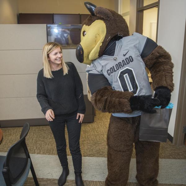 Chip visits Student Support and Case Management staff to hand out gift bags and pose for pictures during Random Acts of Kindness Week
